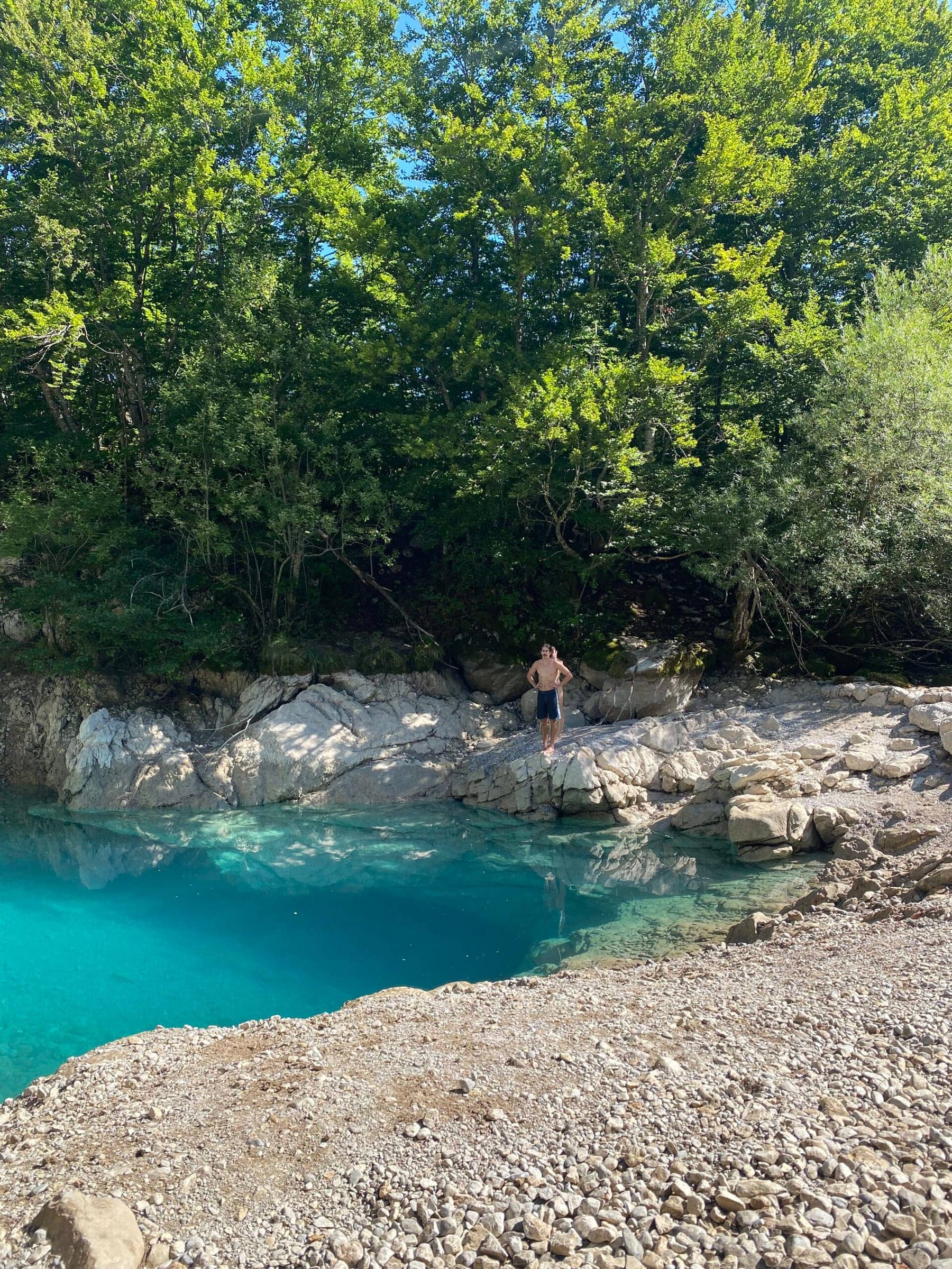 Jake and Anna waiting to dive into the Blue Eye along the Peaks of the Balkans trail