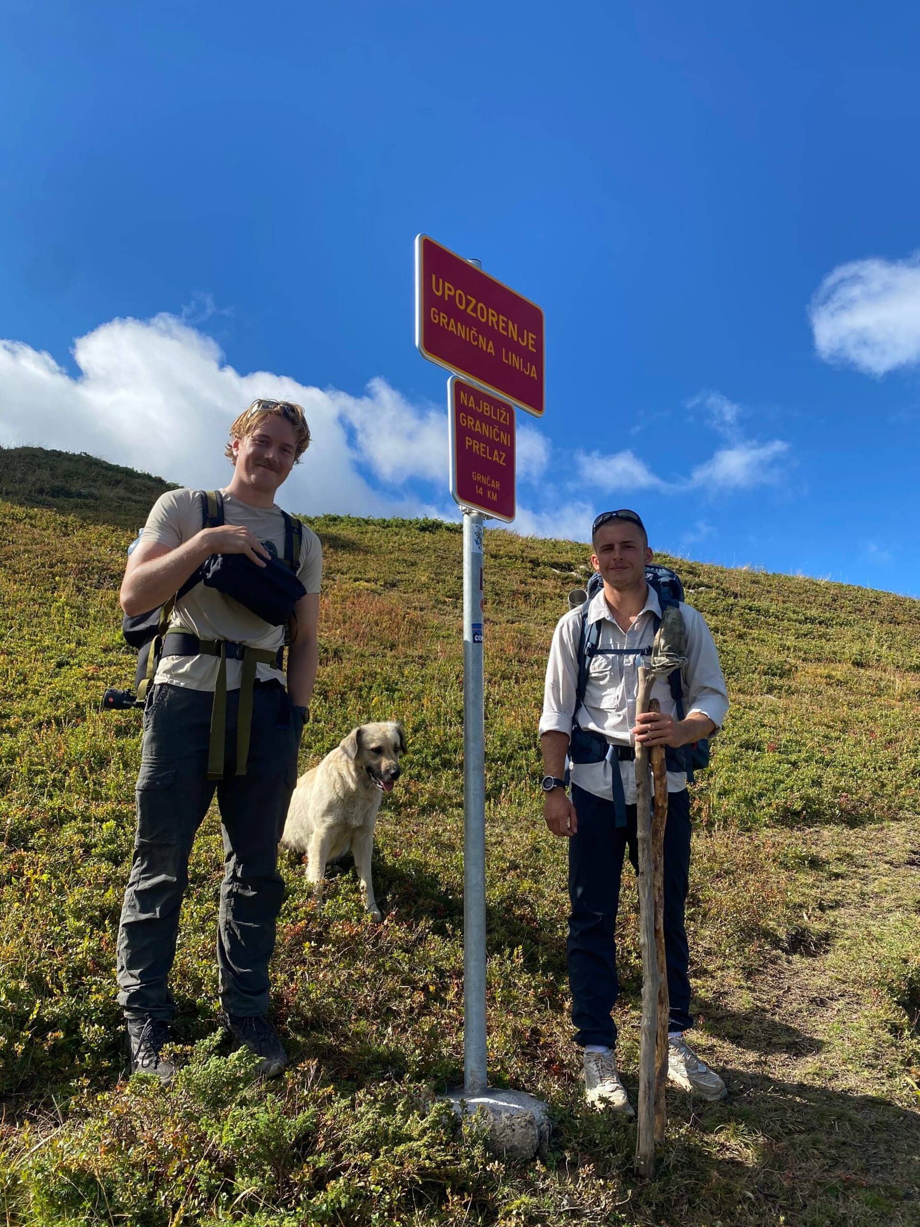 Brian and Gummy pictured with a dog on the three borders summit