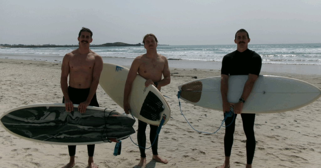 Jake, Brian and Riley standing with their surfboards at La Torche