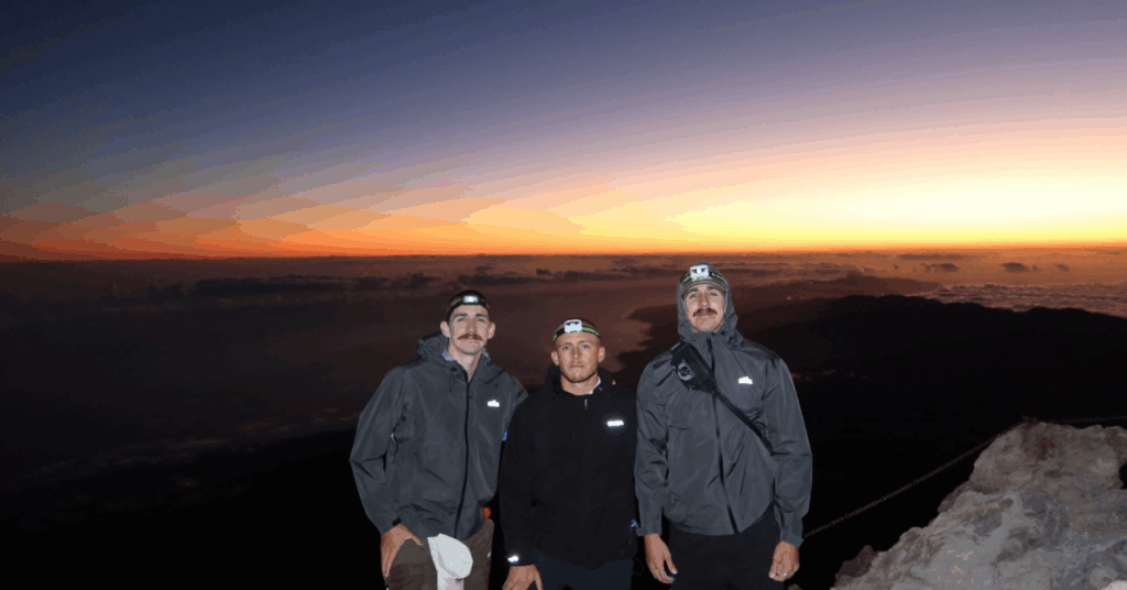 Riley Brazel, Jacob Ghanimeh and Jake Brazel standing on the summit of Mount Teide on Tenerife