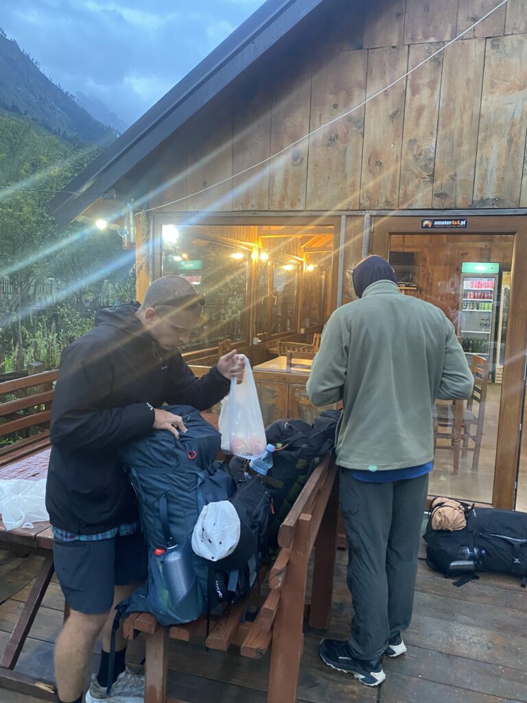 Gummy and Brian packing their lunches for the hike from Valbone to Doberdol