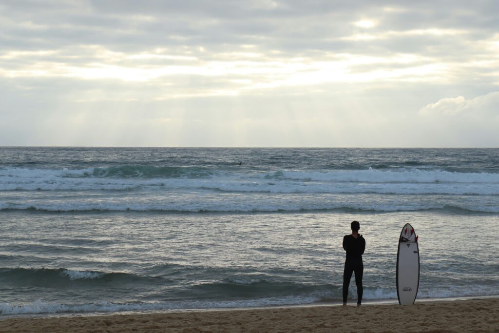 A surfer looking out to the ocean