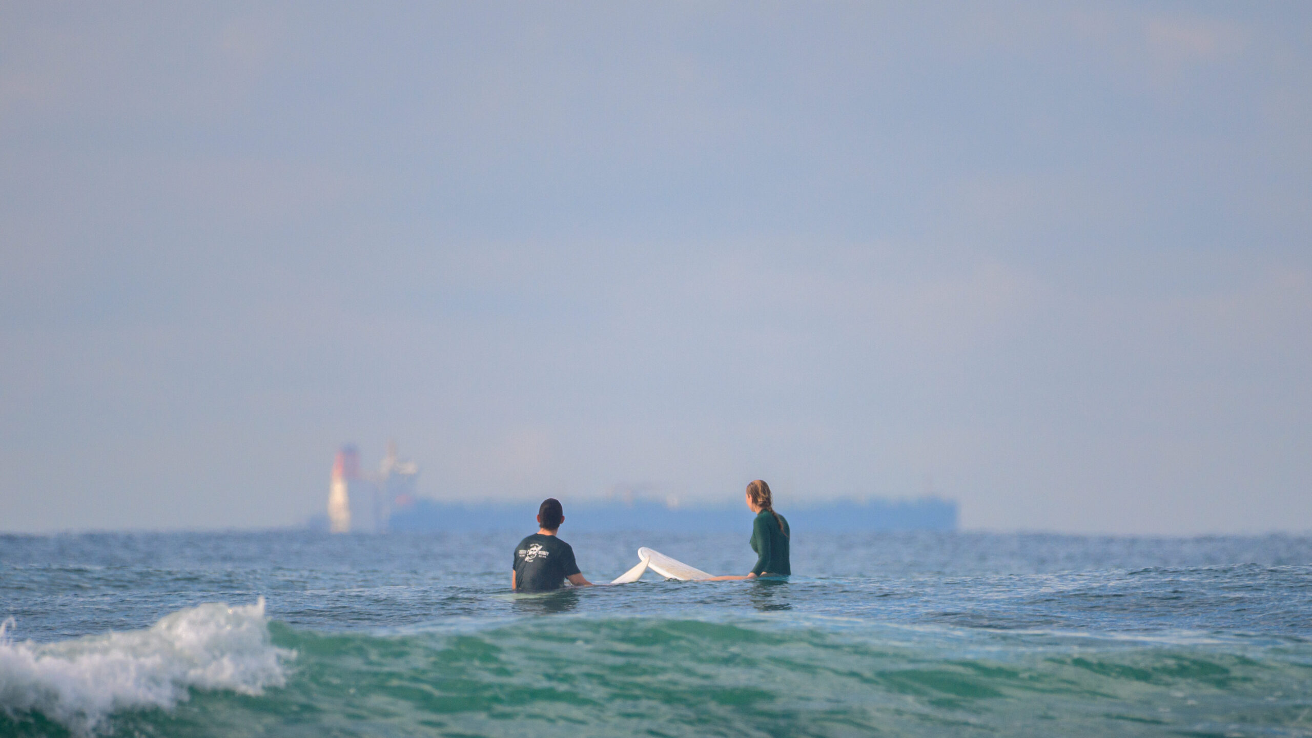 Belle and Riley sitting in the ocean at Animals